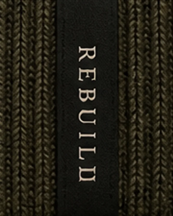 Vertical woven Rebuild label on the back of the olive beanie cuff